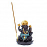 Stand for incense cones with flowing smoke of Ganesha on a lotus flower