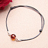 Fashionable string bracelet with an amber bead and Ag 925 silver