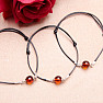 Fashionable string bracelet with an amber bead and Ag 925 silver