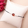 Fashionable string bracelet with an amber bead and Ag 925 silver