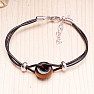 Fashionable string bracelet with a large tiger eye bead