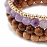 A set of four bracelets made of amethyst, rhodonite, wooden beads and metal