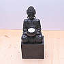 Buddha sitting on a pedestal with a candle stand black statuette