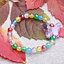 Children&#39;s bracelet with colorful pearls and a butterfly