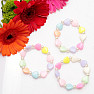 Children&#39;s bracelet made of colored hearts with beads