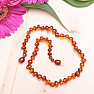 Polished baroque amber beads for children color cognac