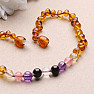 Amber beads for children polished in the color of cognac with a mix of semi-precious stones