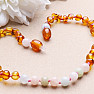 Amber beads for children polished in cognac color with morganite