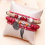 A set of five unisex fashion bracelets in a red tone