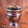 Metal brown bowl in the shape of a cup with chakra symbols