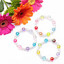 Children&#39;s bracelet made of colored acrylic beads with pearls