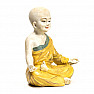 Buddhist monk statuette of a boy in a yellow robe colored