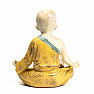 Buddhist monk statuette of a boy in a yellow robe colored