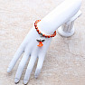 Children&#39;s bracelet made of dark orange glass beads with an angel