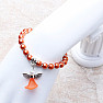 Children&#39;s bracelet made of dark orange glass beads with an angel