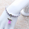 Children&#39;s bracelet made of lilac glass beads with an angel