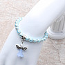 Children&#39;s bracelet made of light blue glass beads with an angel