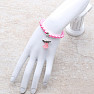 Children&#39;s bracelet made of pink glass beads with an angel