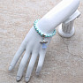 Children&#39;s bracelet made of light turquoise glass beads with an angel