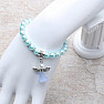 Children&#39;s bracelet made of light turquoise glass beads with an angel