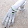 Children&#39;s bracelet made of light green glass beads with an angel