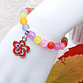 Children's bracelet with colored beads and a flower