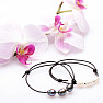 Set of two fashionable leather bracelets with white and black pearls