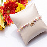 A shimmering bracelet made of colored pearls and glass Aura beads with a lotus flower