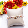 A shimmering bracelet made of colored pearls and glass Aura beads with a lotus flower