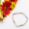 Glittering bracelet made of large white pearls and cut glass beads