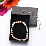 Set of bracelet made of colored pearls and decorative metal bracelet