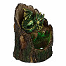 Statuette glowing Green dragon on a tree stump