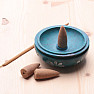 Stand Blue bowl with flowers on incense sticks