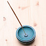 Stand Blue bowl with flowers on incense sticks